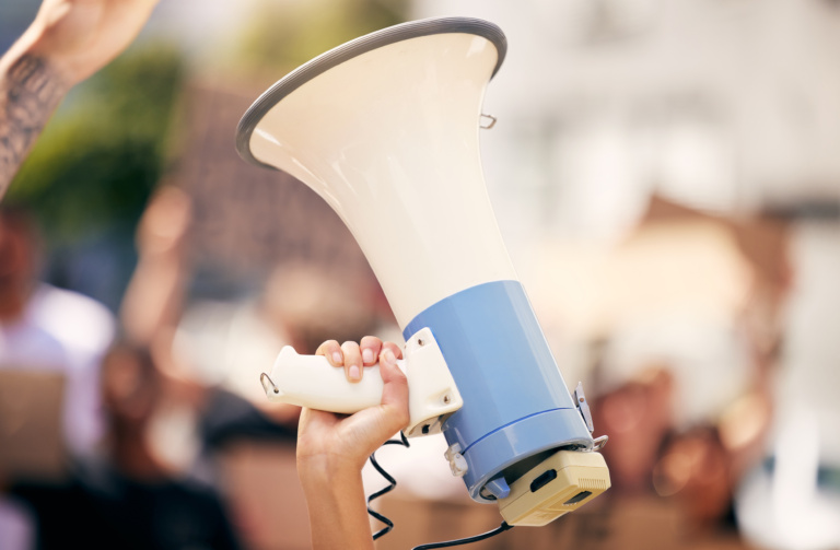 Shot Of A Protester Holding A Megaphone During A Rally