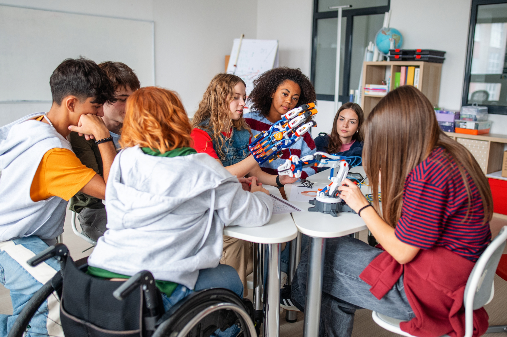 Teen Students Working As A Team On Robotics Project In Classroom.